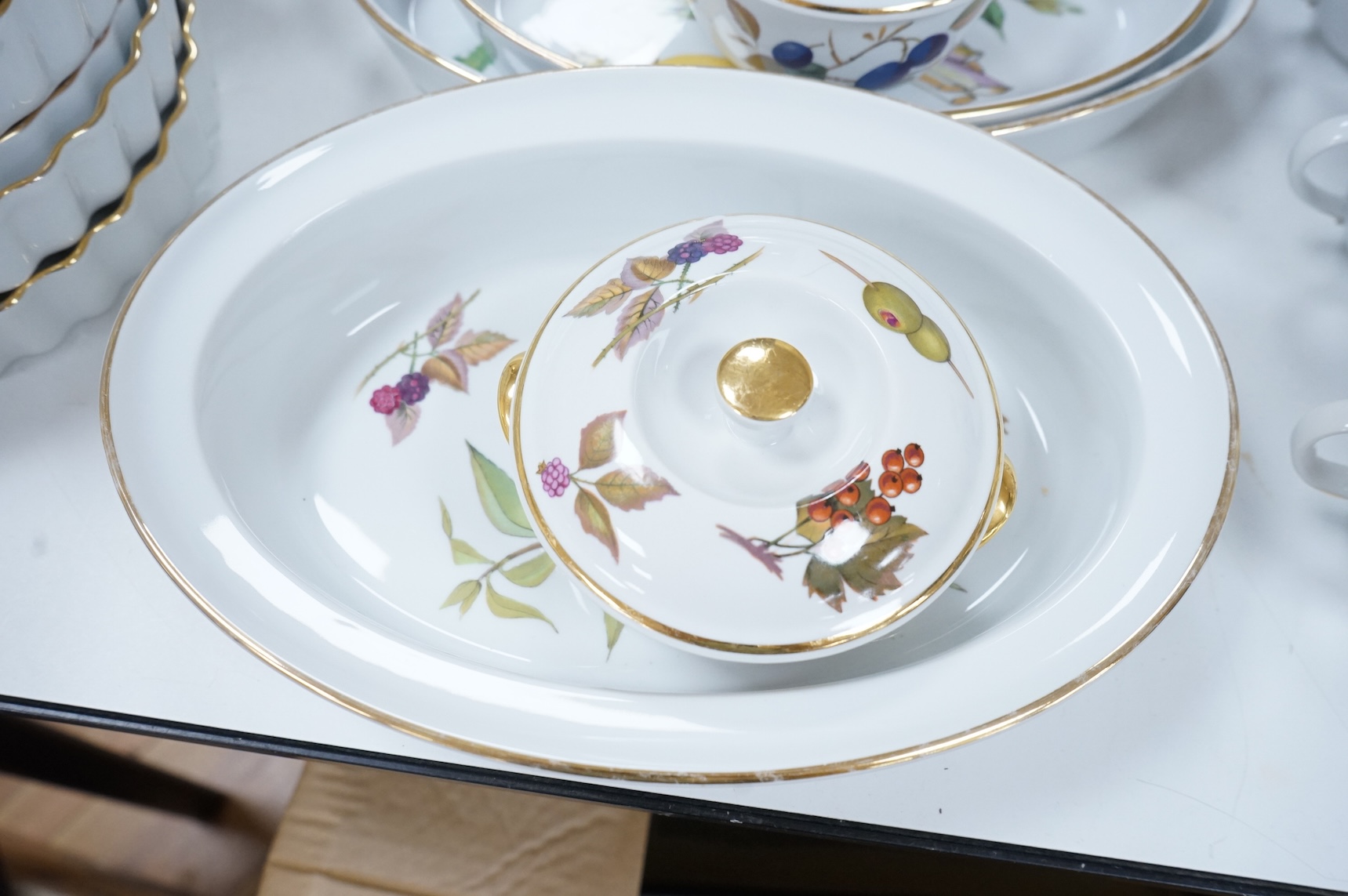 A collection of Royal Worcester Evesham tea and kitchen wares, including storage jars, casserole dishes and cover, flan dishes, serving dishes, tea cups and saucers etc.